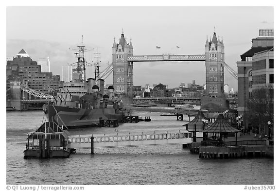 Historic boats, quays along the Thames, and Tower Bridge, late afternoon. London, England, United Kingdom