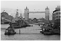 Historic boats, quays along the Thames, and Tower Bridge, late afternoon. London, England, United Kingdom (black and white)