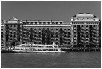 Butler Wharf and tour boat on the Thames. London, England, United Kingdom ( black and white)