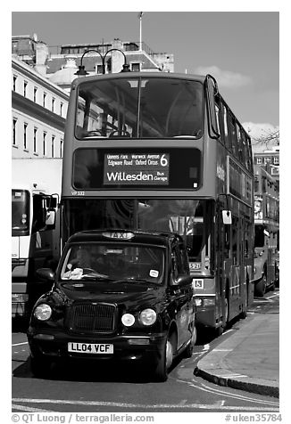 Taxi and double decker bus. London, England, United Kingdom (black and white)