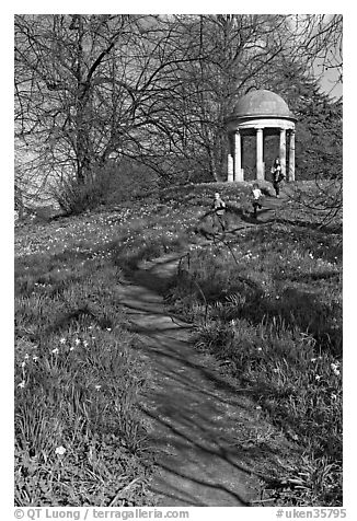 Children running down a trail leading to gazebo. Kew Royal Botanical Gardens,  London, England, United Kingdom