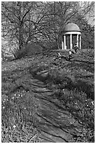 Children running down a trail leading to gazebo. Kew Royal Botanical Gardens,  London, England, United Kingdom (black and white)