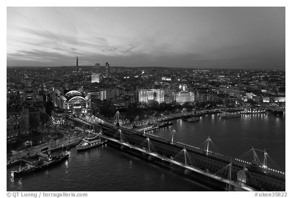 Aerial view of Charing Cross Station, Hungerford Bridge and Golden Jubilee Bridges at sunset. London, England, United Kingdom