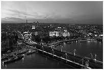 Aerial view of Charing Cross Station, Hungerford Bridge and Golden Jubilee Bridges at sunset. London, England, United Kingdom ( black and white)