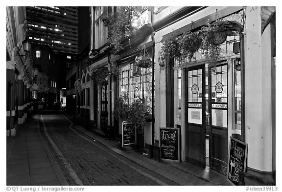 Saloon bar and cobblestone alley at night. London, England, United Kingdom