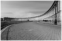 Cobblestone pavement and curved facade of Royal Crescent. Bath, Somerset, England, United Kingdom ( black and white)