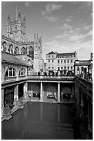 Great Bath Roman building, with Abbey in background. Bath, Somerset, England, United Kingdom (black and white)