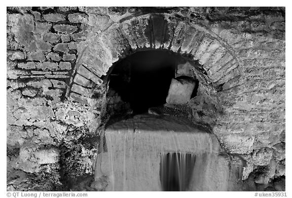 Roman-built brick channel overflow from the sacred spring. Bath, Somerset, England, United Kingdom (black and white)