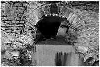 Roman-built brick channel overflow from the sacred spring. Bath, Somerset, England, United Kingdom ( black and white)