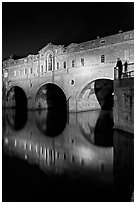 Man looking at the Pulteney Bridge  at night. Bath, Somerset, England, United Kingdom ( black and white)