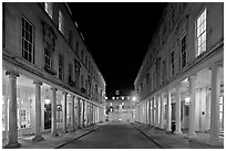 Street bordered by colonades at night. Bath, Somerset, England, United Kingdom ( black and white)