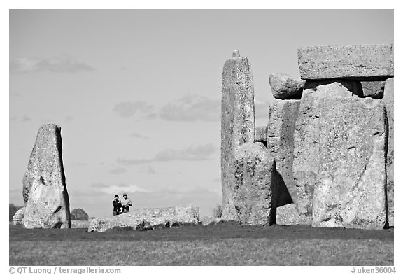 Couple looking at the standing stones, Stonehenge, Salisbury. England, United Kingdom (black and white)