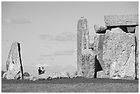 Couple looking at the standing stones, Stonehenge, Salisbury. England, United Kingdom ( black and white)