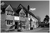 Street lined with stone houses, Lacock. Wiltshire, England, United Kingdom ( black and white)