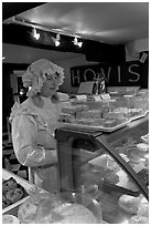 Woman wearing old-fashioned attire in a bakery, Lacock. Wiltshire, England, United Kingdom (black and white)