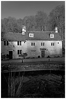 Cotswold type houses and Bybrook River, Castle Combe. Wiltshire, England, United Kingdom (black and white)