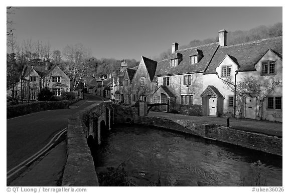 Main village street and Bybrook River, late afternoon, Castle Combe. Wiltshire, England, United Kingdom (black and white)