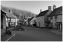 Main village street,  half timbered Court House, and Butter Cross, Castle Combe. Wiltshire, England, United Kingdom ( black and white)