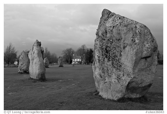 Standing stone circle and village house at dusk, Avebury, Wiltshire. England, United Kingdom