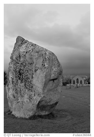 Standing stone and chapel at dusk, Avebury, Wiltshire. England, United Kingdom (black and white)