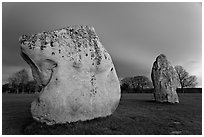Large standing stones and brewing storm at dusk, Avebury, Wiltshire. England, United Kingdom ( black and white)