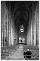 Man sitting in the Nave of the Canterbury Cathedral. Canterbury,  Kent, England, United Kingdom ( black and white)