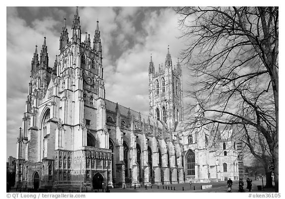 Canterbury Cathedral with people strolling on precincts. Canterbury,  Kent, England, United Kingdom (black and white)