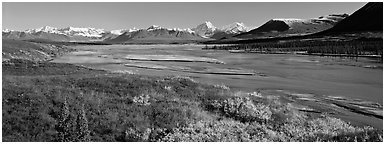 Tundra autumn scenery with wide river and mountains. Alaska, USA (Panoramic black and white)