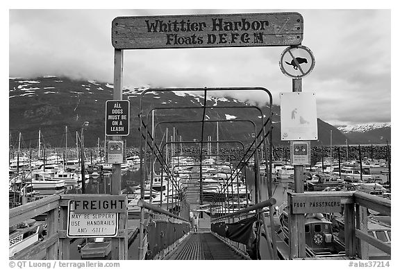 Ramp to harbor deck with Whittier sign. Whittier, Alaska, USA (black and white)