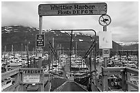 Ramp to harbor deck with Whittier sign. Whittier, Alaska, USA (black and white)