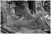 Woman repairing net on fishing boat. Whittier, Alaska, USA (black and white)