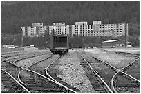 Rail tracks and Buckner building. Whittier, Alaska, USA (black and white)