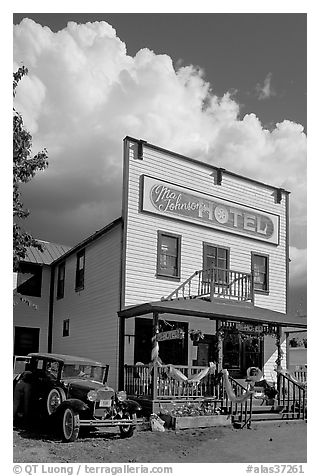 Ma Johnson hotel with classic car parked by, afternoon. McCarthy, Alaska, USA