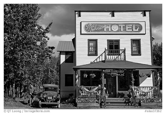 Small hotel with classic car parked by, afternoon. McCarthy, Alaska, USA (black and white)