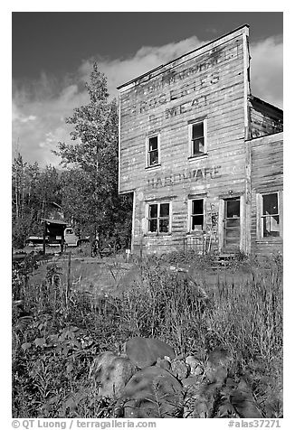 Weathered facade of old hardware store. McCarthy, Alaska, USA (black and white)