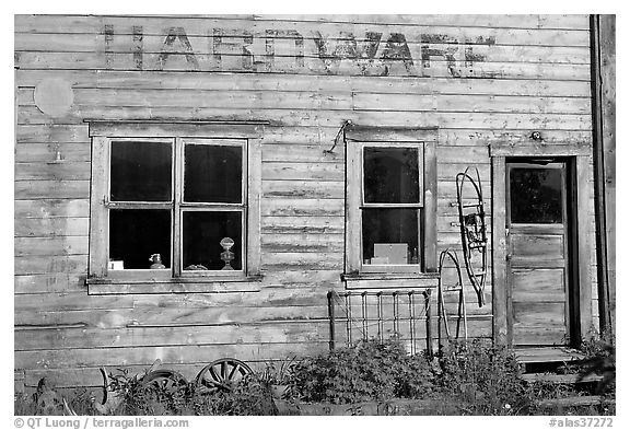 Windows and doors of old hardware store. McCarthy, Alaska, USA (black and white)