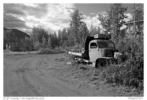 Side street with wrecked truck. McCarthy, Alaska, USA