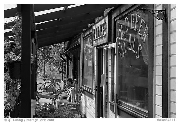 Man sitting in front of McCarthy lodge. McCarthy, Alaska, USA (black and white)