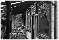 Man sitting in front of McCarthy lodge. McCarthy, Alaska, USA (black and white)