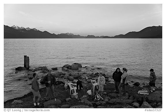 Families pickniking with fire, Resurrection Bay, sunset. Seward, Alaska, USA