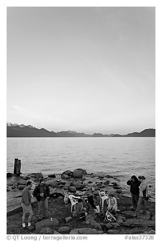 Family enjoying midnight picknik, Resurrection Bay, sunset. Seward, Alaska, USA