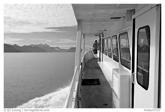 Passenger standing outside tour boat. Seward, Alaska, USA