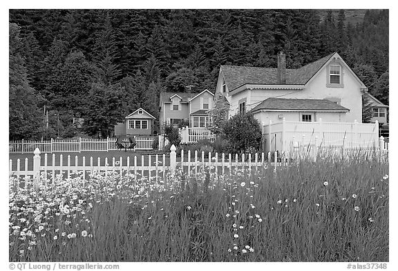 White picket fence and houses with pastel trims. Seward, Alaska, USA (black and white)