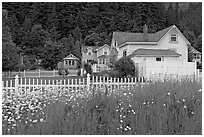 White picket fence and houses with pastel trims. Seward, Alaska, USA (black and white)