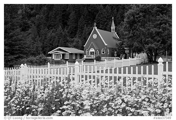 Flowers, white picket fence and church. Seward, Alaska, USA