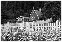 Flowers, white picket fence and church. Seward, Alaska, USA ( black and white)