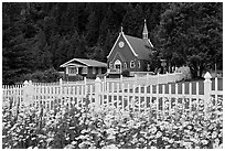 Flowers, white picket fence and church. Seward, Alaska, USA (black and white)