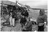 Inupiaq Eskimo family with stand of drying fish, Ambler. North Western Alaska, USA (black and white)