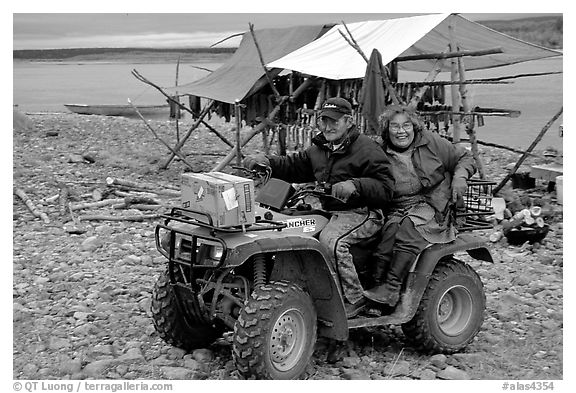 Inupiaq Eskimo man and woman riding on a four-wheeler, Ambler. North Western Alaska, USA