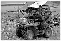 Inupiaq Eskimo man and woman riding on a four-wheeler, Ambler. North Western Alaska, USA ( black and white)